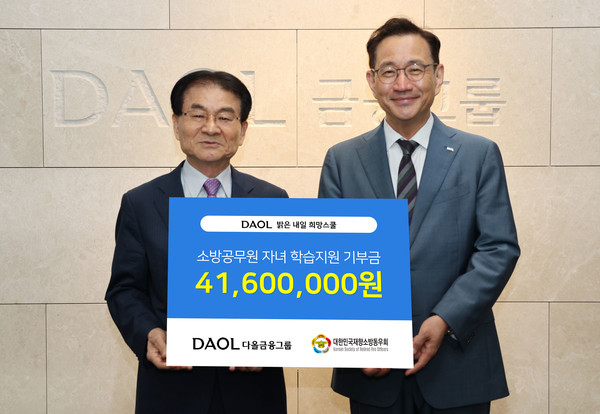 대한민국재향소방동우회 김철종 상임고문(왼쪽)과 다올금융그룹 김태우 ESG위원이 소방공무원 자녀를 위한 기부금을 전달하고 기념촬영을 하고 있다. 사진=다올금융그룹