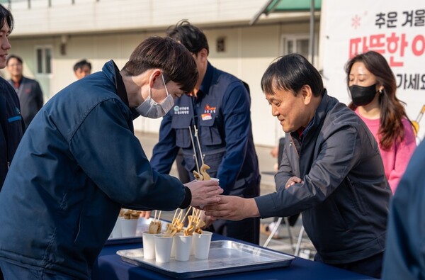 김종화 SK에너지 사장이 '2025 SK이노베이션 협력사 상생기금 전달식' 현장에 마련된 어묵 푸드트럭에서 협력사 구성원들에게 어묵꼬치를 나눠주는 모습. 사진=SK이노베이션